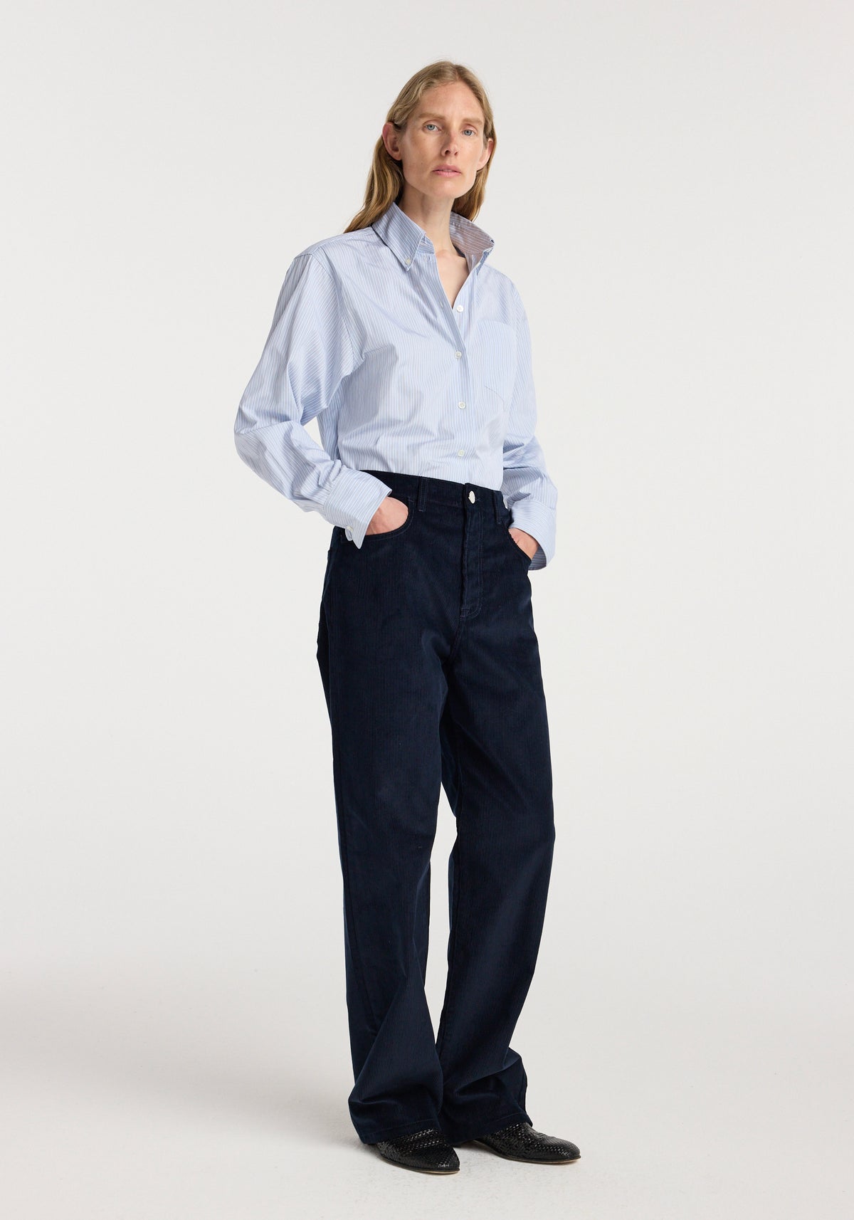 Bruun - Signature baggy corduroy | night worn by a model with a light blue shirt and black shoes in a studio setting