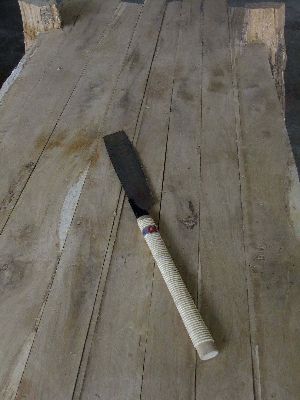 Japanese wood saw on a wooden surface