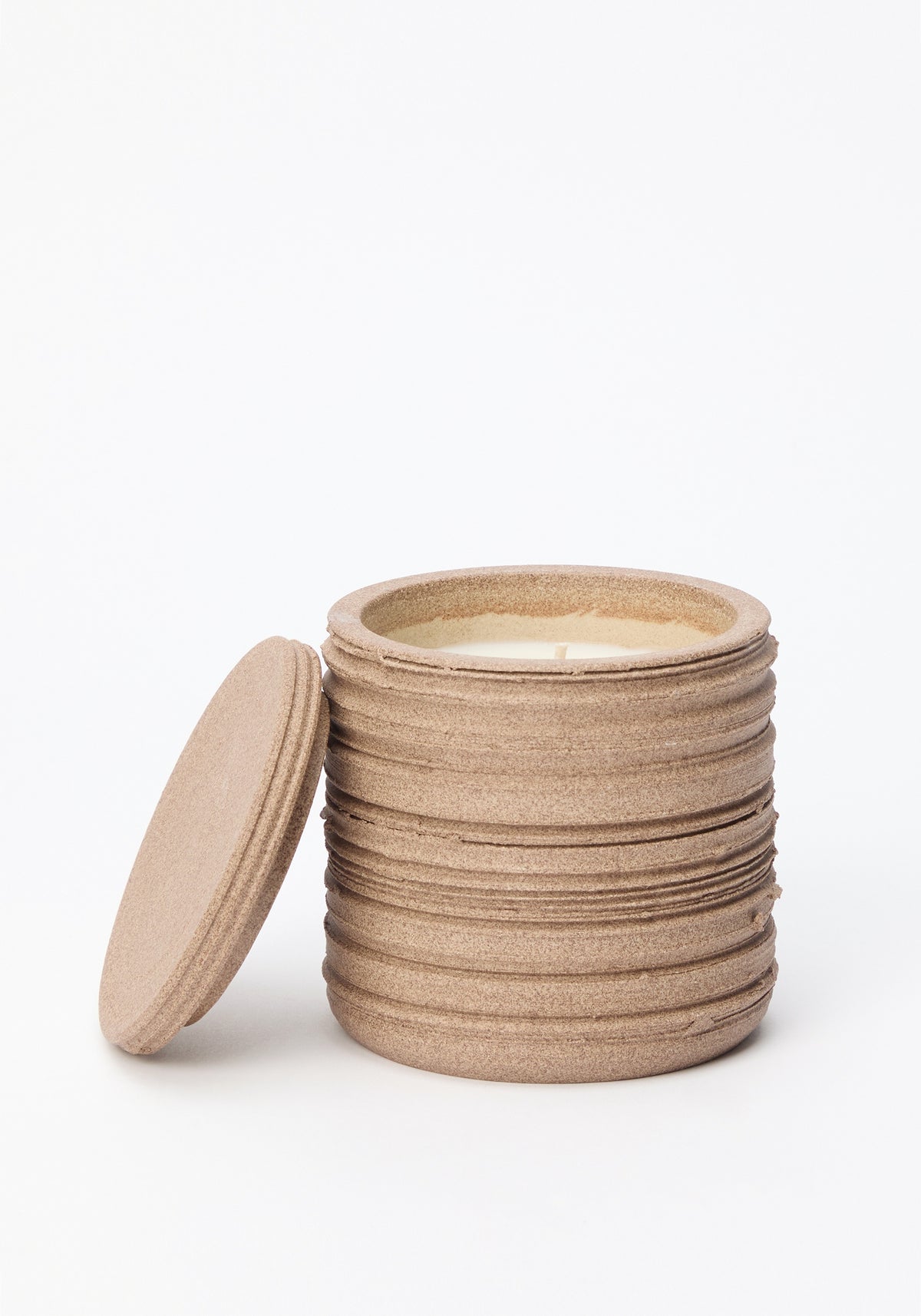Diplomatico Scented Candle | clay in a textured, ribbed clay container with a matching lid placed beside it, showcasing the candle wax inside.