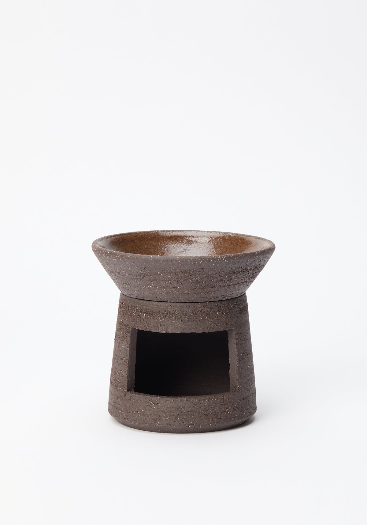 Minimalist brown ceramic oil burner with a round top bowl and hollow center base, designed for holding a tea light candle, Ceramic Oil Burner | soil.