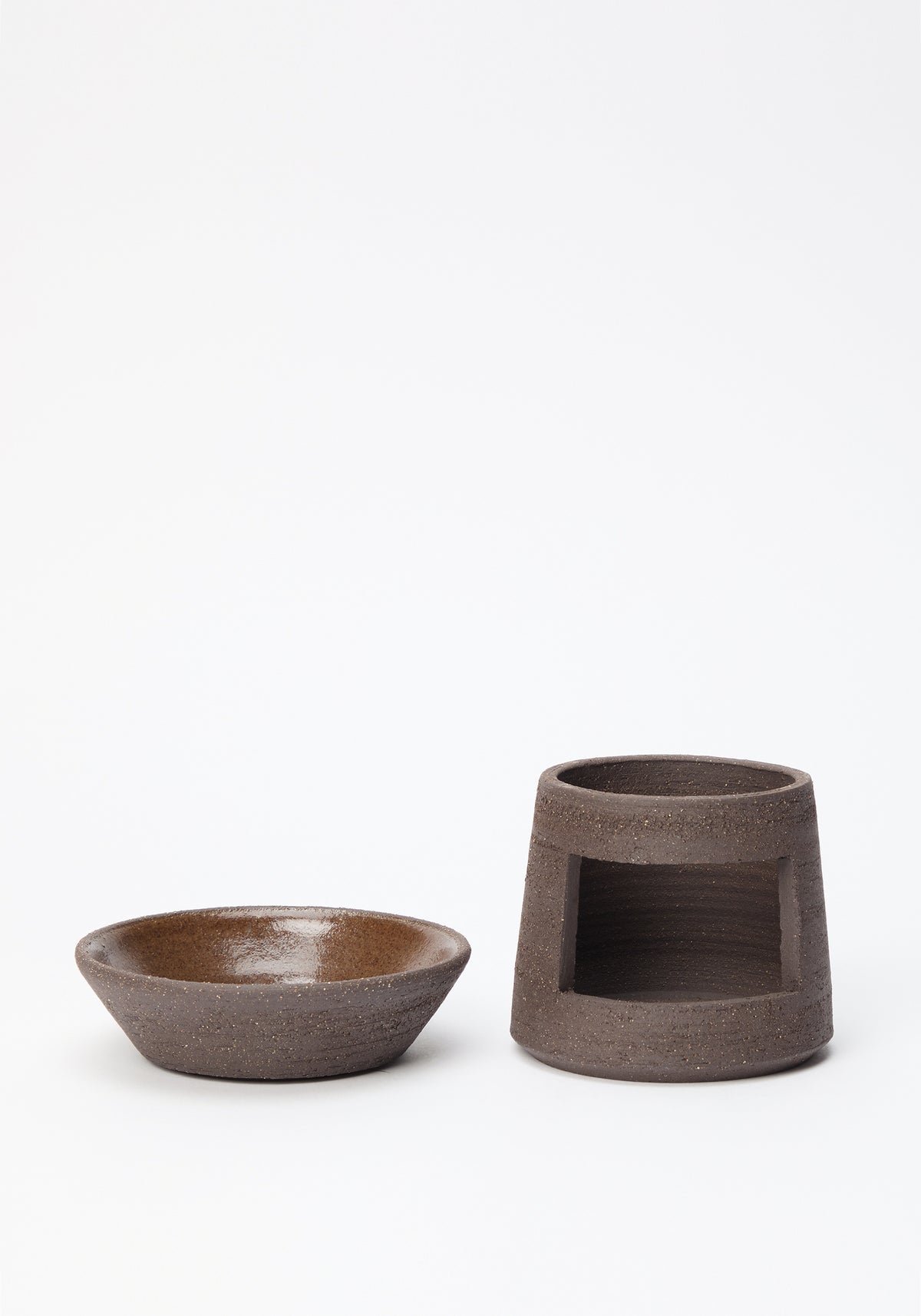 Minimalist brown ceramic oil burner with a textured matte finish, consisting of a bowl and a hollow base, designed for use as a Ceramic Oil Burner | soil.