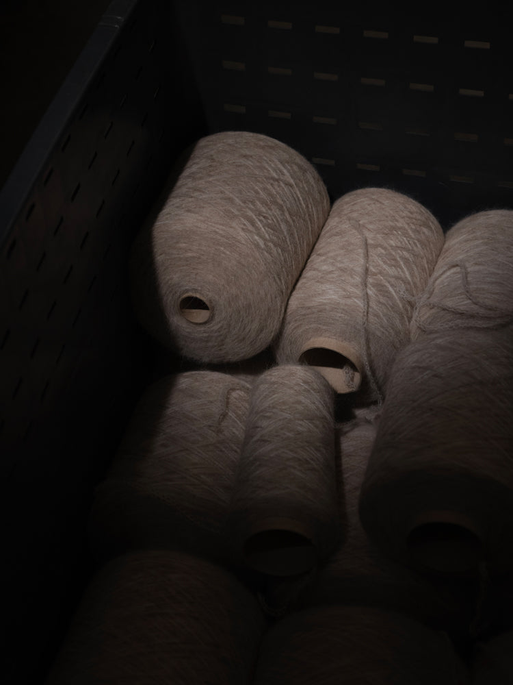 Bundles of yarn in a dark storage bin