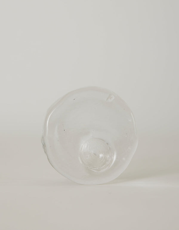Presse-papier & holder | Glass: Hand-blown, transparent glass object with wavy edges and a central dome, showcasing Szkło Studio's unique, functional glass artistry.