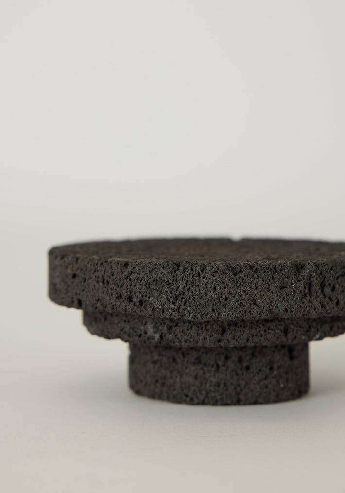 Elevated Sculptural Tray made of handcrafted lava stone; features a round platform with a two-tiered design, showcasing its unique, porous texture.
