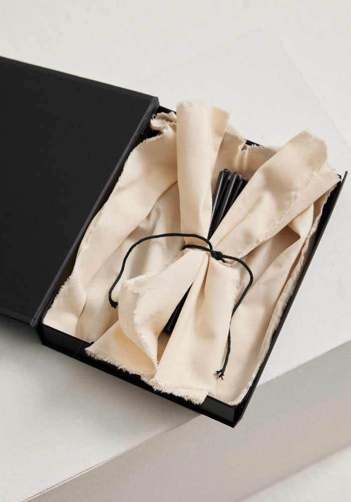 Candles 5mm | noir set in a matte-black gift box with a natural cotton lining, showcasing bundled long black candles made of 100% beeswax.