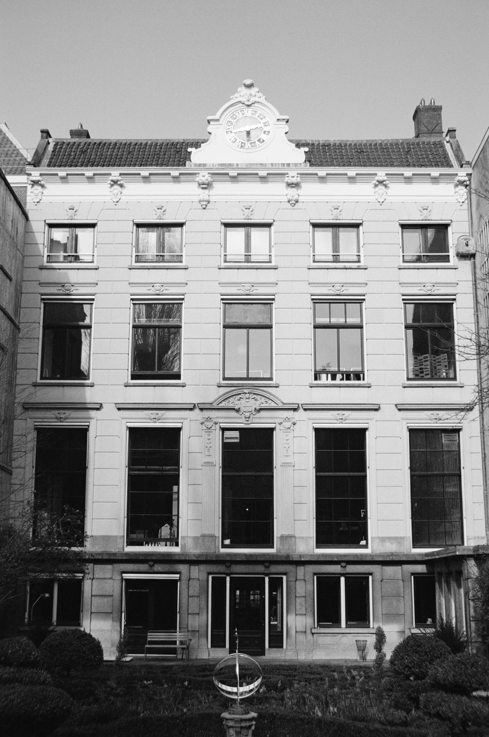 Black and white photo of a classical building facade with decorative elements.