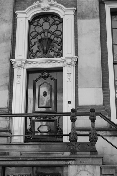 Decorative architectural detail of a door in a building facade with intricate carvings.