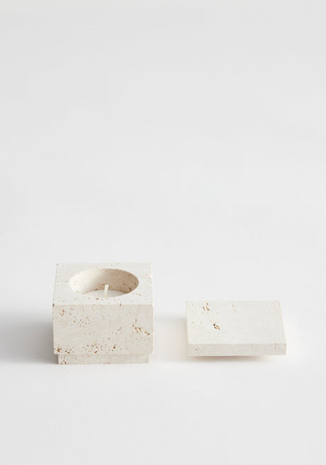 Tealight box | travertine: A handcrafted, light stone square holder with a round well for a candle, featuring a removable matching lid, made from leftover travertine.
