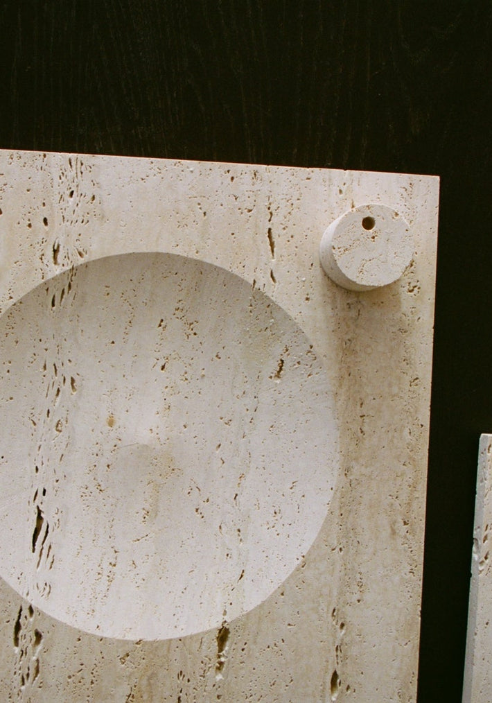 Small tray | travertine: Two light-beige travertine slabs feature a round, carved indent and a small circular relief, showcasing minimalistic, handcrafted design by Louis Crombag.