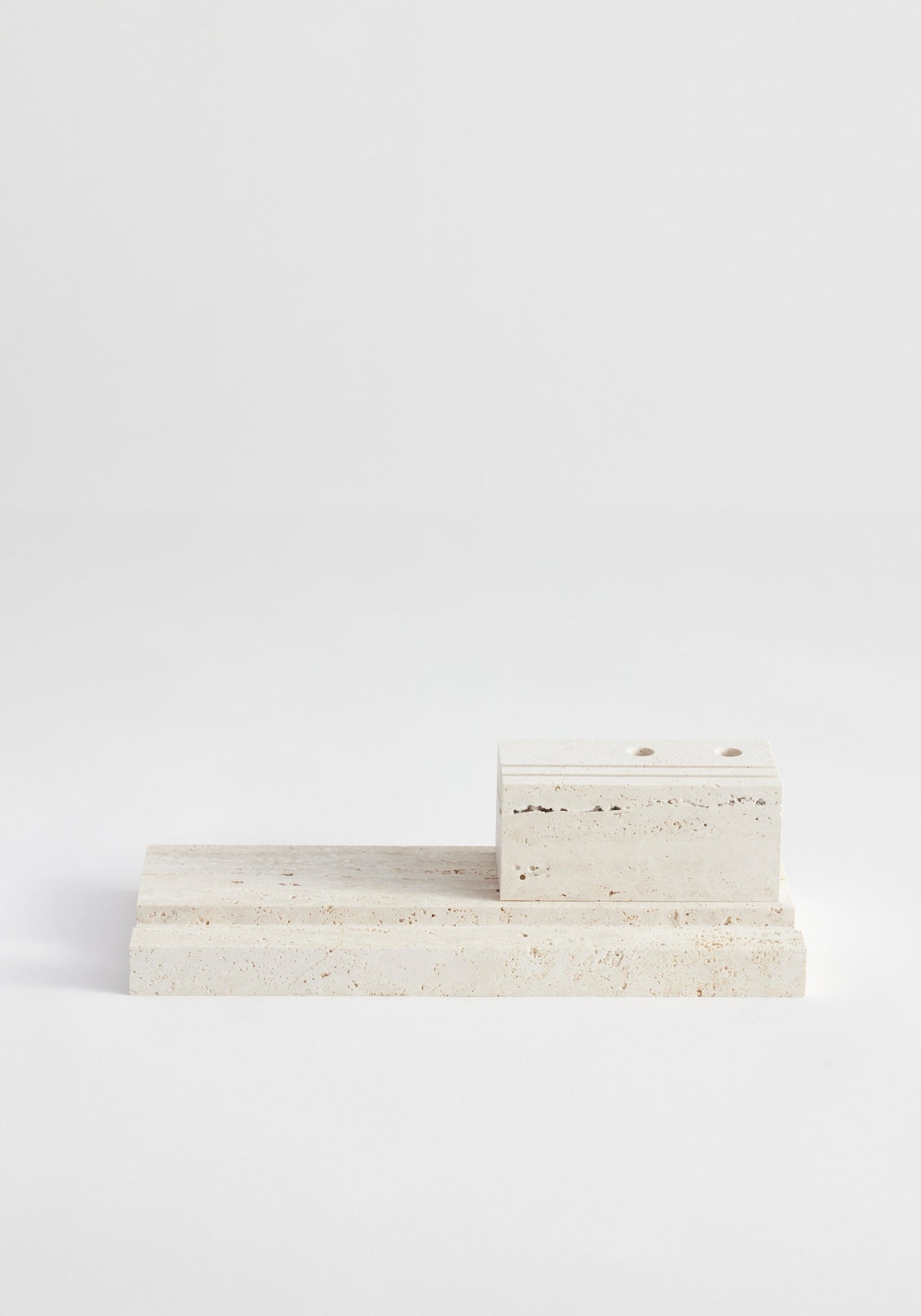 Desk organizer | travertine: Two-piece set with a rectangular base and smaller block, handcrafted by Louis Crombag from leftover Italian travertine, featuring pen holders.