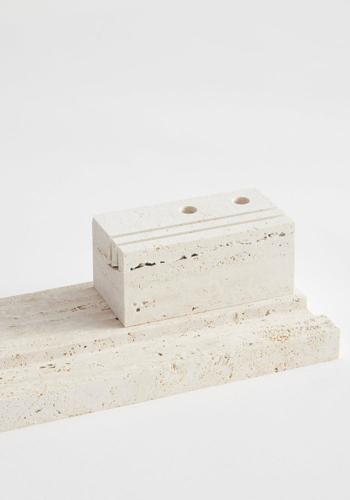 Travertine desk organizer featuring a flat slab base and a grooved block with two holes, handcrafted by Dutch artist Louis Crombag.