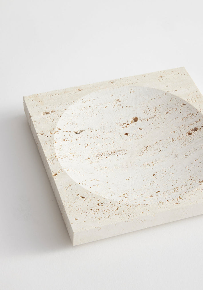Small tray | travertine: Square stone tray with a round carved indent, handcrafted from leftover Italian travertine by artist Louis Crombag in the Netherlands.