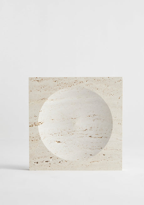 Medium tray | travertine: A square travertine block with a round, shallow indent, handcrafted by Louis Crombag, showcasing its natural porous texture and unique design.