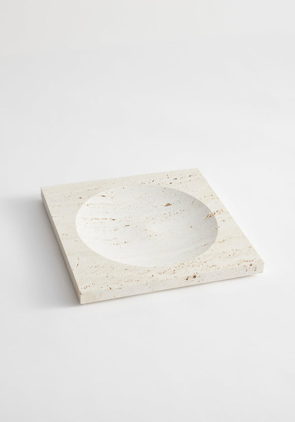 Medium tray | travertine: A handcrafted square stone tray with a central round indent, made from natural Italian travertine by artist Louis Crombag in the Netherlands.