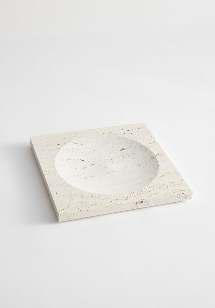 Medium tray | travertine: A handcrafted square stone tray with a central round indent, made from natural Italian travertine by artist Louis Crombag in the Netherlands.