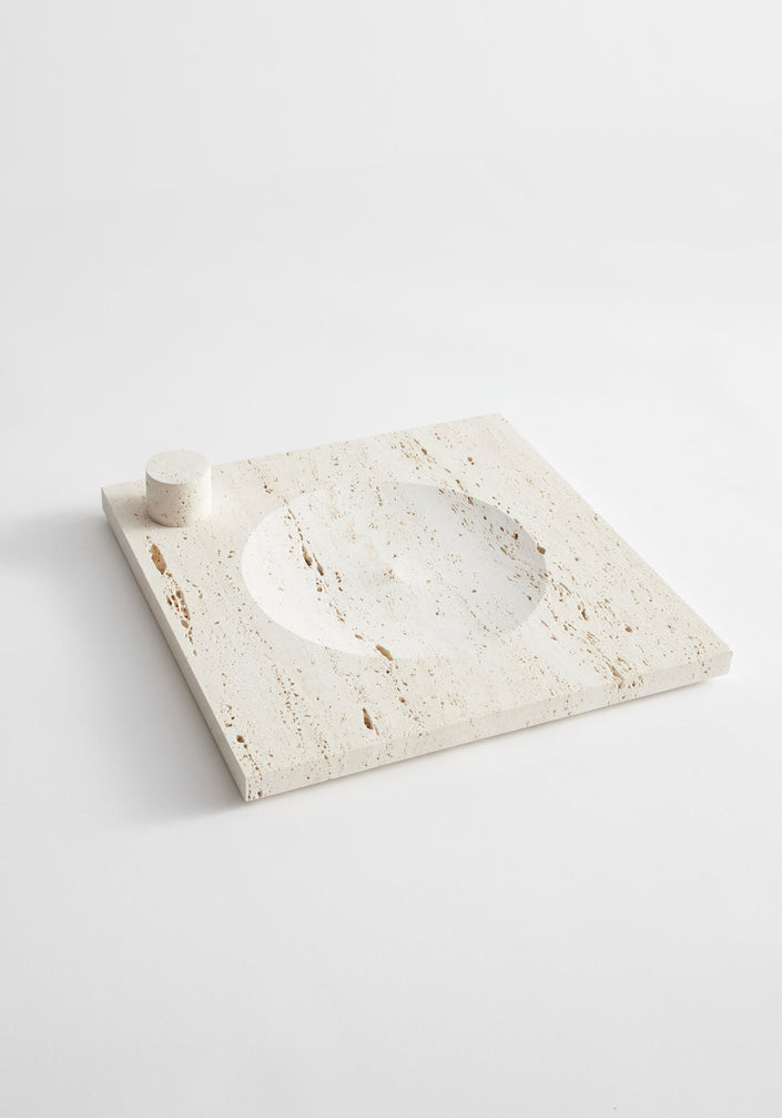 Large tray | travertine: A cream travertine slab with a circular recess and cylindrical holder for incense or candles, handcrafted by Louis Crombag in the Netherlands.