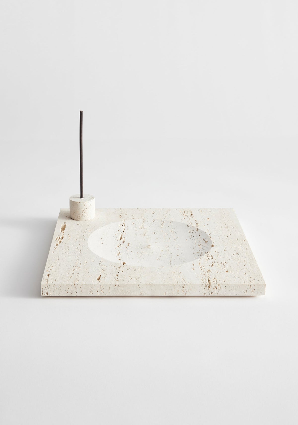 Large tray | travertine: A cream travertine slab with a circular recess and cylindrical holder for incense or candles, handcrafted by Louis Crombag in the Netherlands.