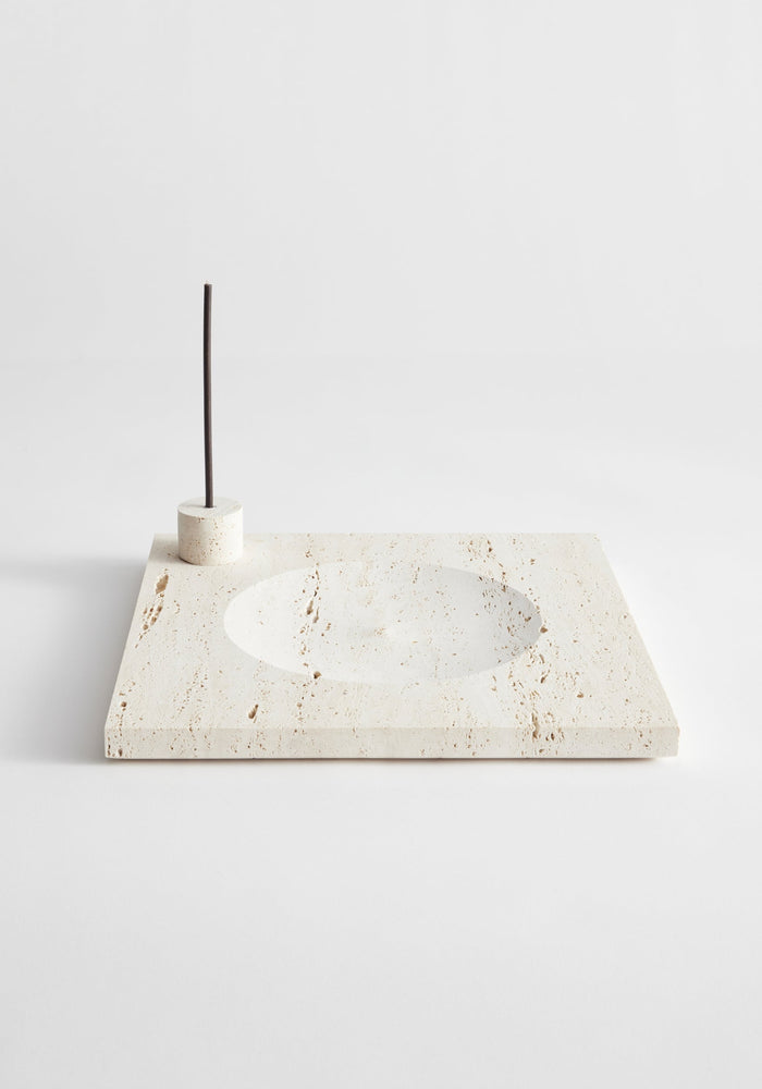 Large tray | travertine: A cream travertine slab with a circular recess and cylindrical holder for incense or candles, handcrafted by Louis Crombag in the Netherlands.