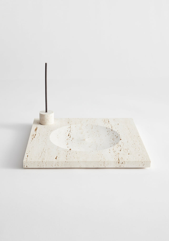 Large tray | travertine: A cream travertine slab with a circular recess and cylindrical holder for incense or candles, handcrafted by Louis Crombag in the Netherlands.