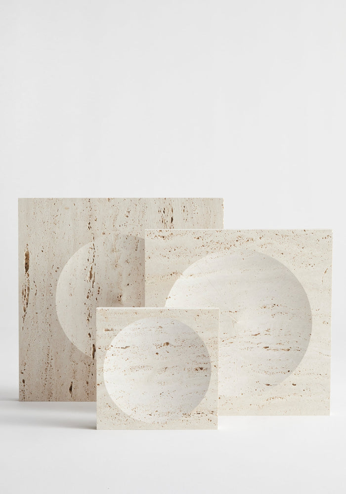Large tray | travertine: Three pale travertine slabs with circular indents, handcrafted by Louis Crombag, showcasing unique, minimalist design.