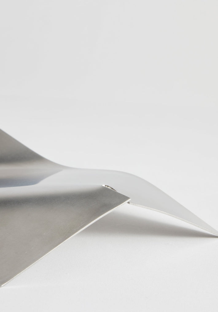 Stainless steel bowl featuring minimal, bent design by Paul Coenen, showcasing overlapping polished metal sheets, handcrafted in the Netherlands.