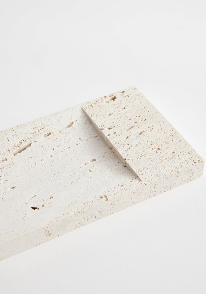 Incense holder tray | travertine: Two rectangular travertine slabs, one atop the other, showcasing unique natural pitted texture. Handcrafted by Louis Crombag, Netherlands.