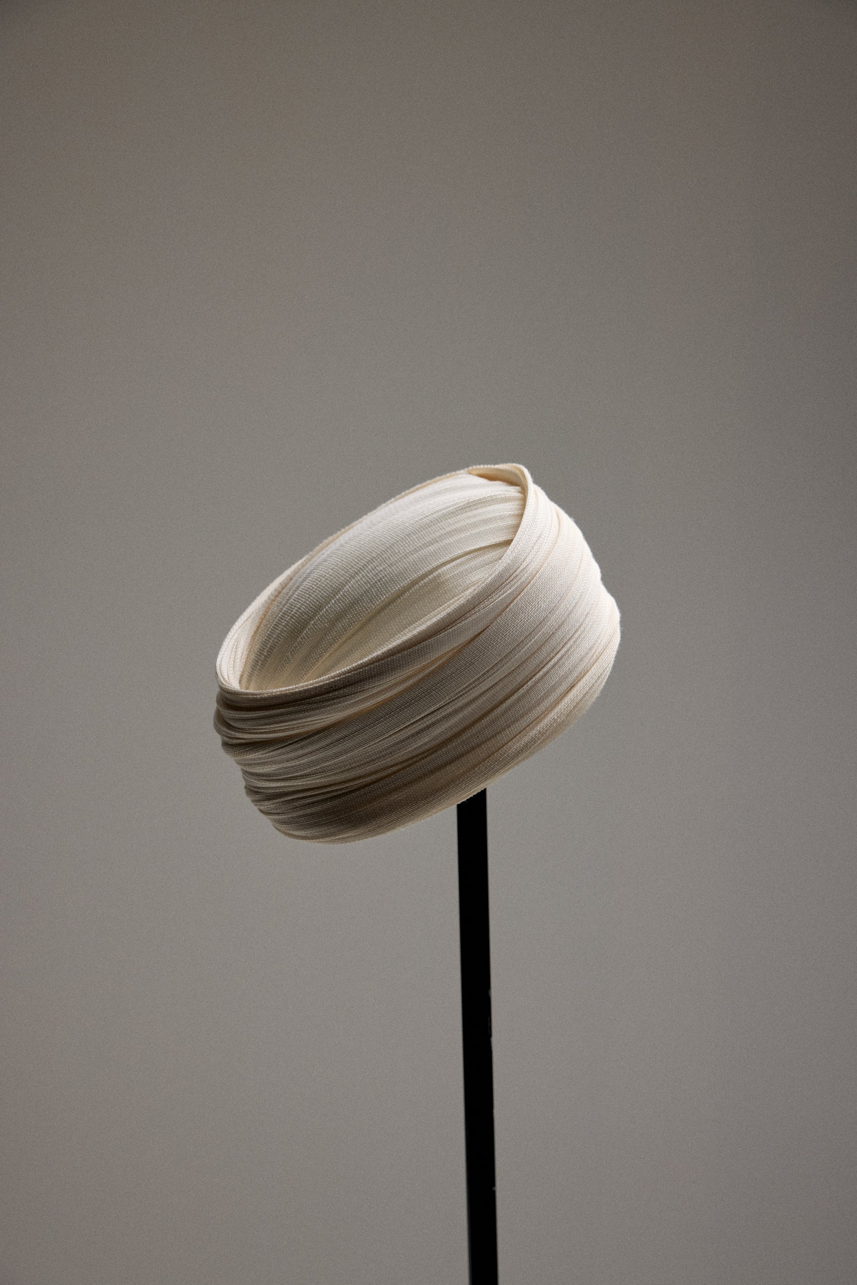 White tule hat on a stand. 