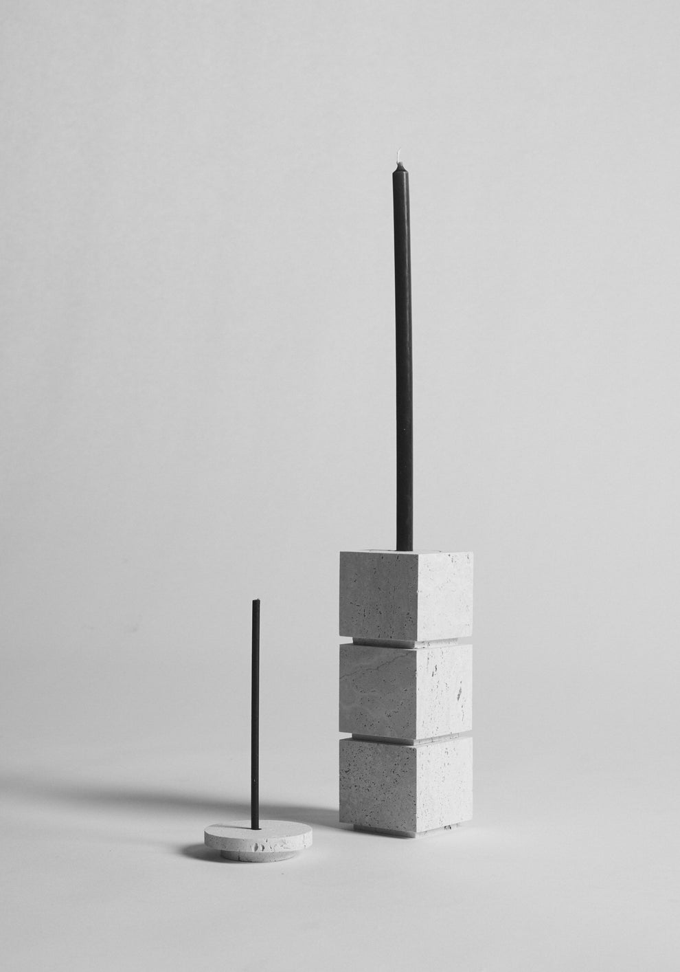 Two travertin candle holders on a white background