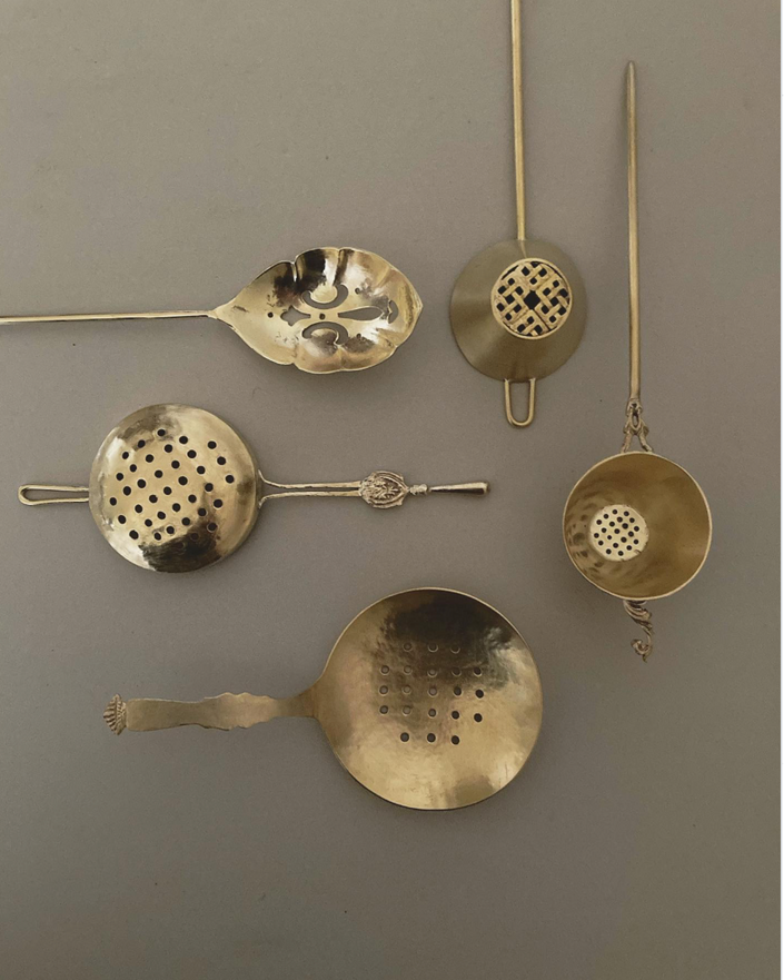 Tea Strainer collection handcrafted by Misae Nikkei, featuring various brass designs with perforated bowls, ideal for straining tea, scooping pickles, or sifting spices.