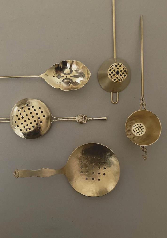 Tea Strainer collection handcrafted by Misae Nikkei, featuring various brass designs with perforated bowls, ideal for straining tea, scooping pickles, or sifting spices.