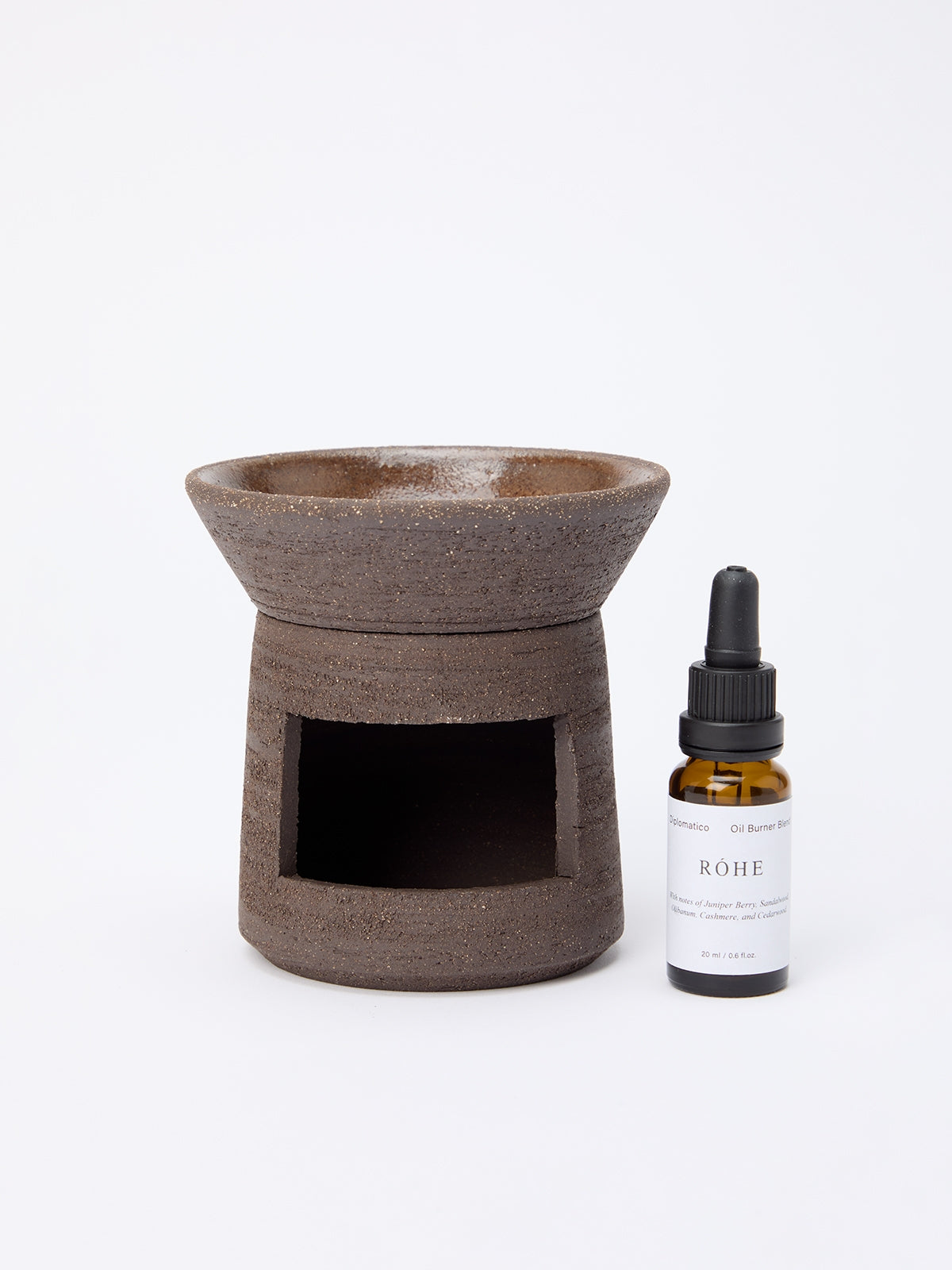Ceramic Oil Burner | soil in natural brown with a textured finish, accompanied by a small amber dropper bottle of essential oil on a white background.